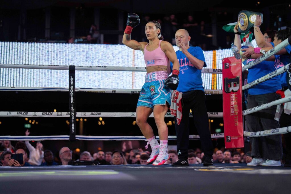 Amanda Galle rises her fist after a defining victory, a symbol of resilience, purpose and strength