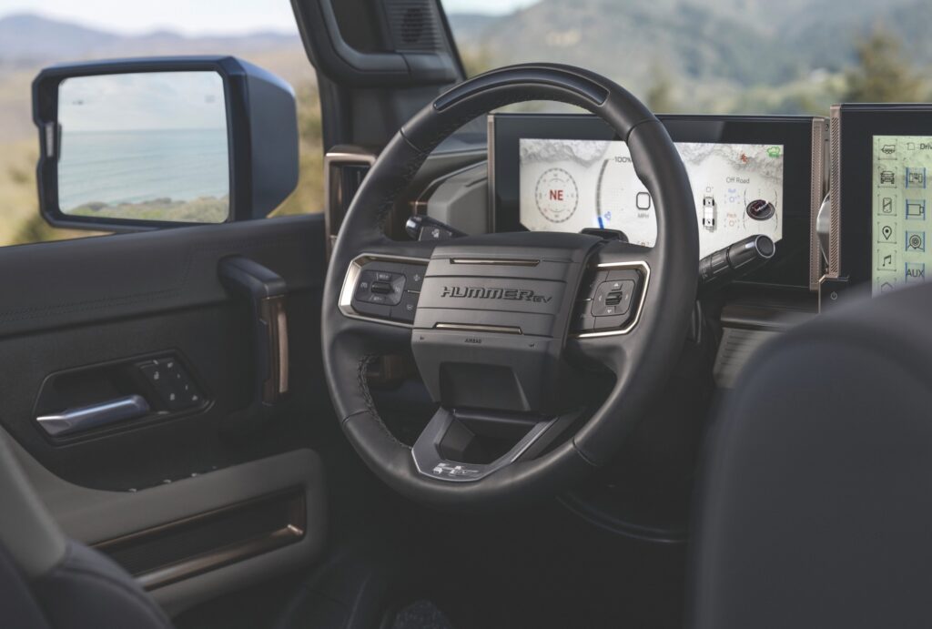 Interior of the 2025 Hummer EV featuring premium finishes, digital displays, and modern designs.