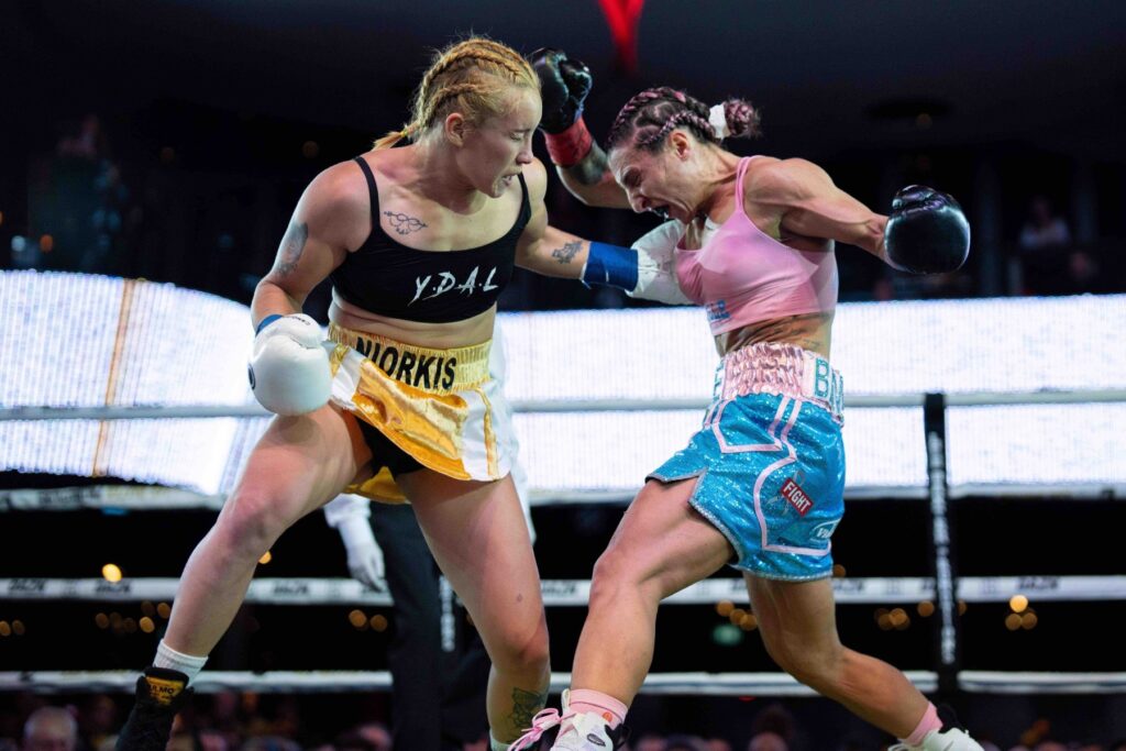 Amanda Galle delivers a powerful body punch during the title fight.